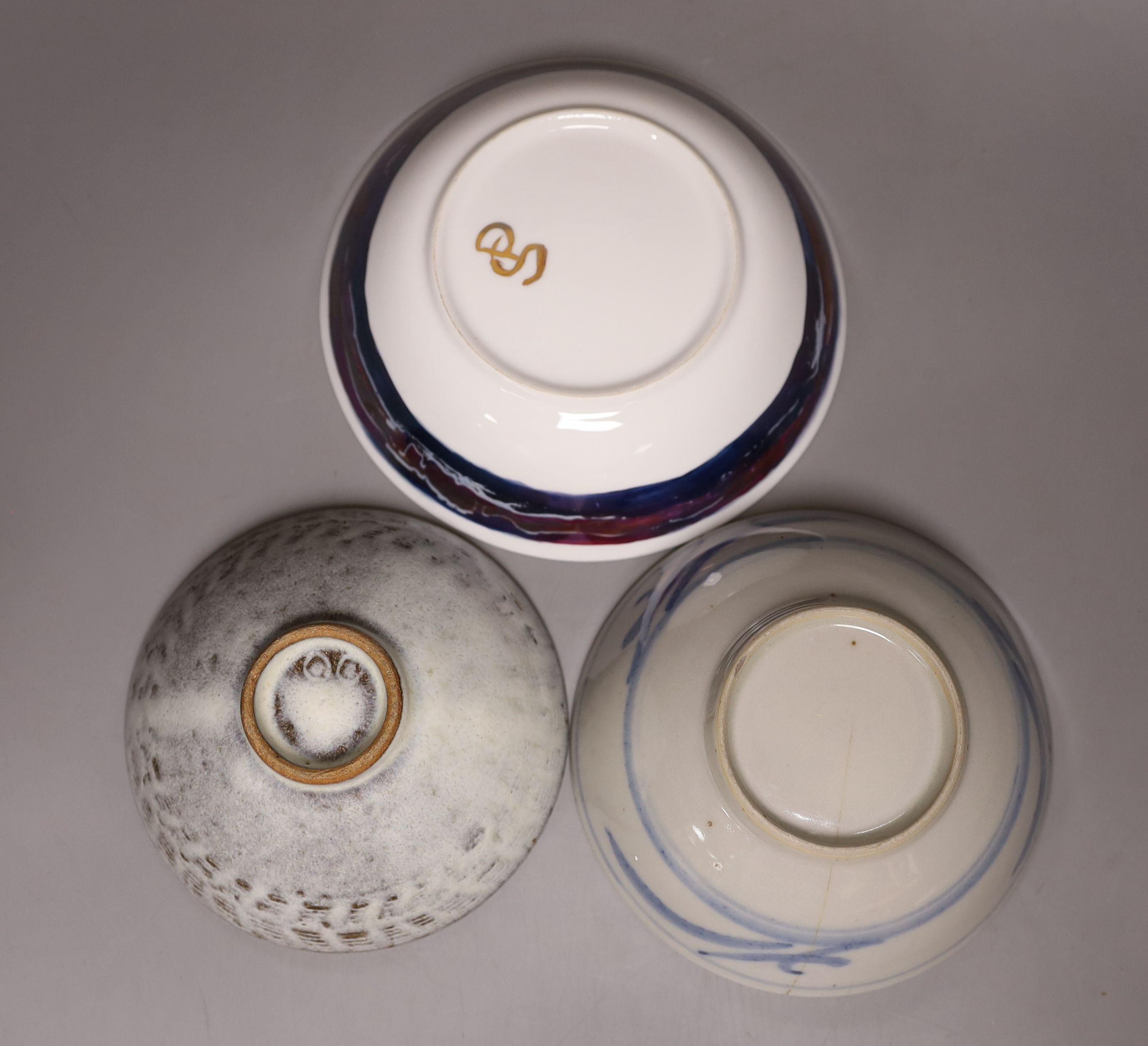 Two studio pottery bowls and a Chinese blue and white bowl, largest 18cm